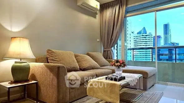 Modern living room with cozy sofa and city view balcony in high-rise apartment.