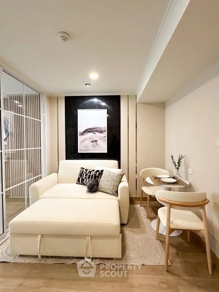 Modern living room with stylish decor and cozy seating area in a contemporary apartment.