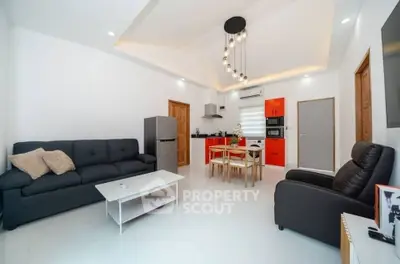 Modern living room with stylish furniture and open kitchen layout
