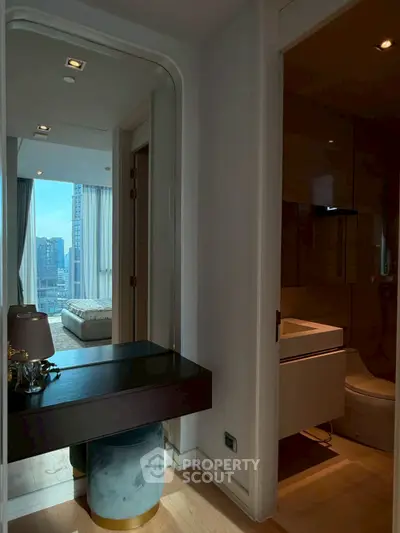 Modern apartment interior with city view, featuring a stylish bedroom and bathroom.