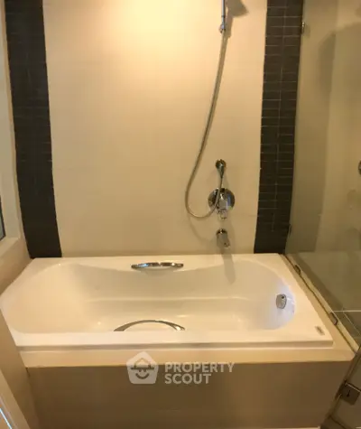 Modern bathroom with sleek bathtub and shower setup