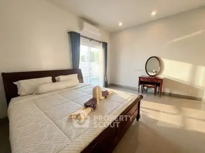 Spacious bedroom with elegant decor and natural light