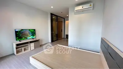Modern minimalist bedroom with air conditioning and TV, perfect for comfort and relaxation.