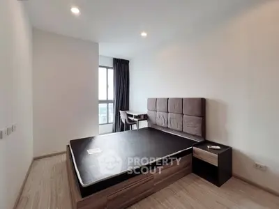 Modern minimalist bedroom with large window and stylish furniture