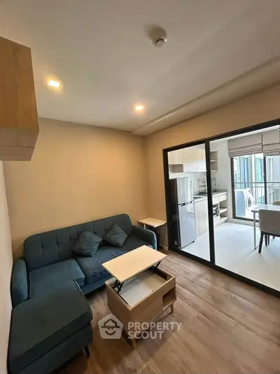Modern living room with stylish furniture and open kitchen layout