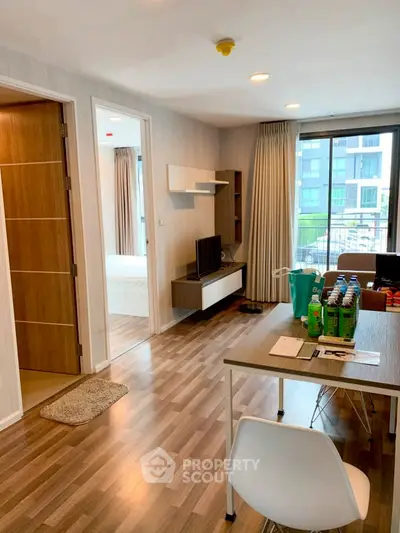 Modern apartment interior with wooden flooring and natural light