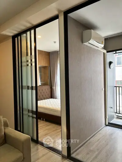 Modern bedroom with sliding glass doors and air conditioning unit