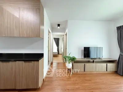 Modern living room with wooden flooring and sleek cabinetry