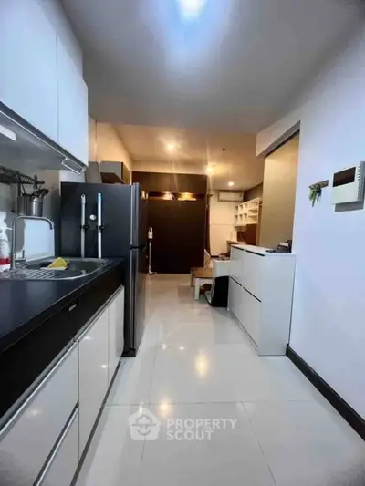 Modern kitchen with sleek cabinetry and open layout in stylish apartment