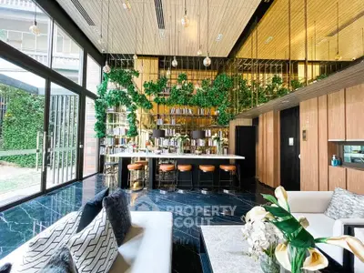Luxurious modern living room with stylish bar and lush greenery accents