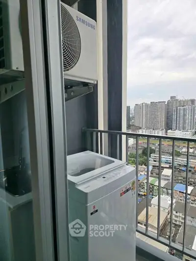 High-rise balcony with washing machine and cityscape view, perfect for urban living convenience.