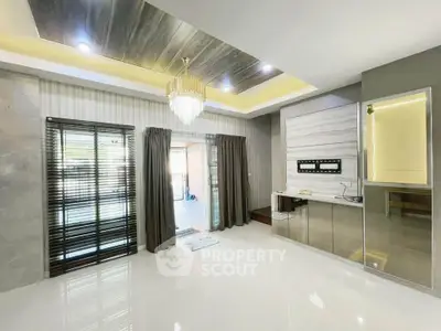 Luxurious modern living room with chandelier and sleek design