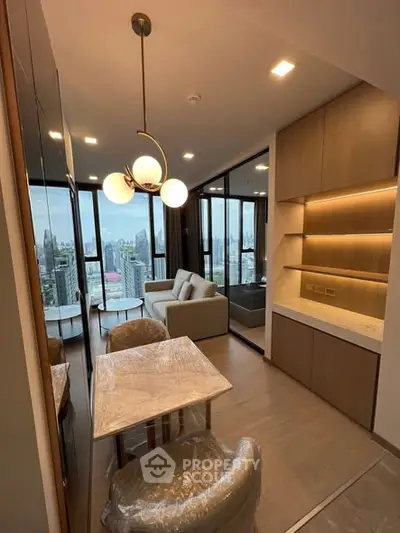 Modern living room with city view, stylish lighting, and cozy seating area in a high-rise apartment.