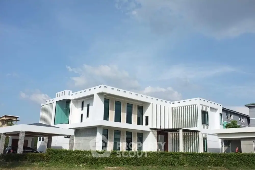 Modern architectural masterpiece with sleek design and expansive windows in a serene neighborhood.