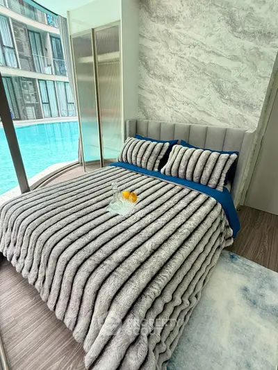 Luxurious bedroom with pool view, featuring plush bedding and modern design for ultimate comfort and style.