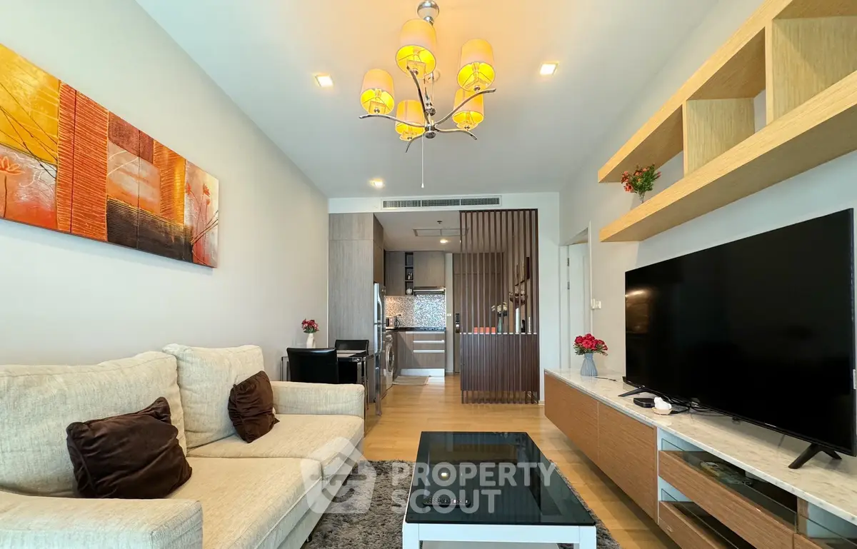 Modern living room with stylish decor and open kitchen layout in a contemporary apartment.
