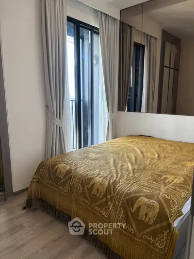 Cozy bedroom with elegant decor and large windows for natural light