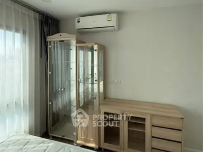 Modern bedroom with glass cabinet and air conditioning unit