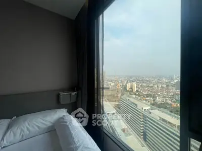 Stunning city view from a modern high-rise bedroom window, offering a serene urban escape.