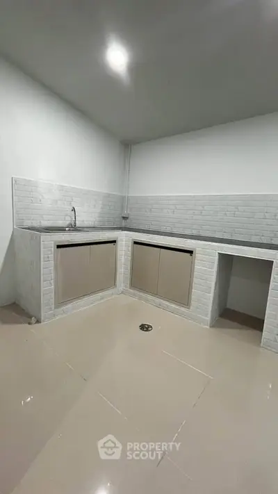 Modern minimalist kitchen with sleek cabinetry and tiled backsplash