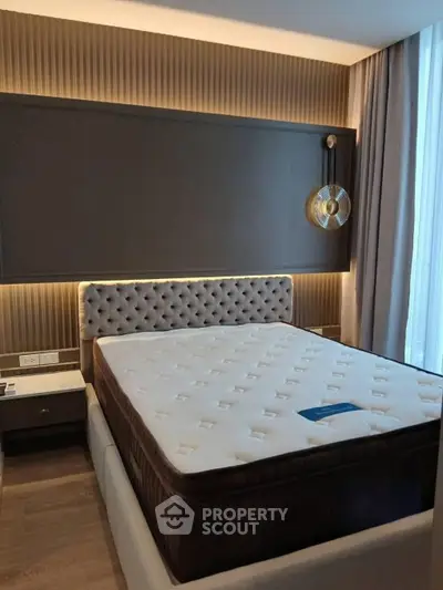 Luxurious bedroom with elegant lighting and plush bed in modern apartment
