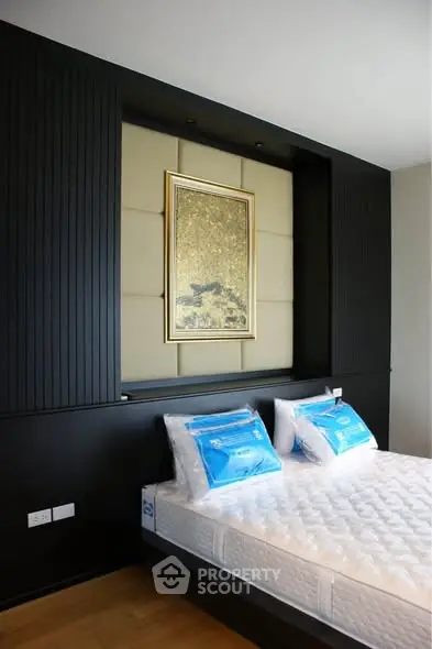 Modern bedroom with stylish black paneling and elegant wall art