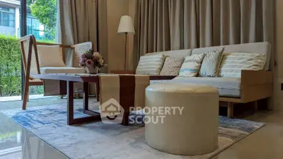 Elegant living room with modern furniture and large window view