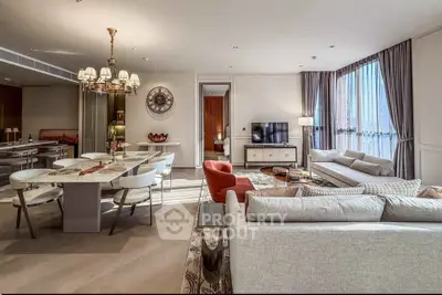 Luxurious open-plan living and dining area with elegant furnishings and ample natural light.