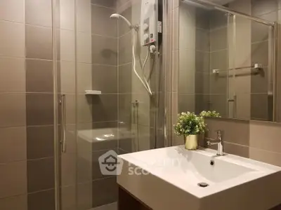 Modern bathroom with sleek shower and stylish sink in contemporary design.