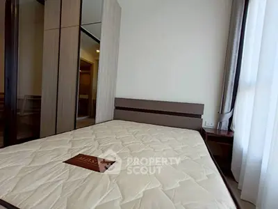 Modern bedroom with sleek wardrobe and comfortable bed in a stylish apartment.