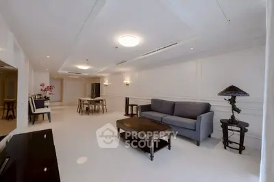 Spacious modern living room with elegant decor and ample natural light.