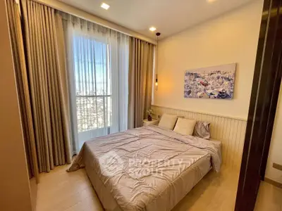 Cozy bedroom with large window and elegant curtains, perfect for relaxation.