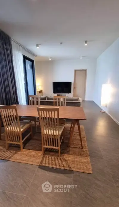 Spacious modern living room with dining area and large windows for natural light.