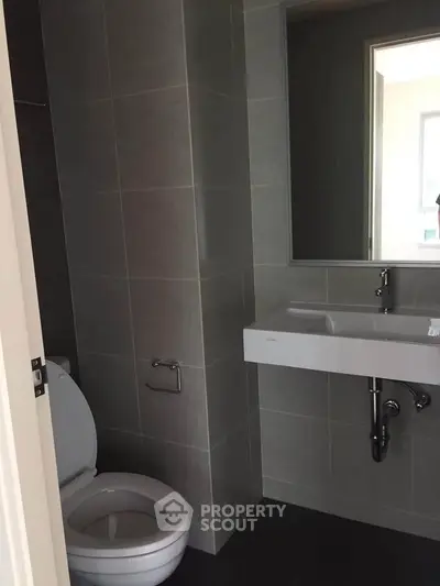 Modern bathroom with sleek gray tiles and contemporary fixtures