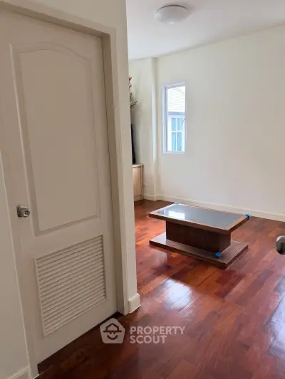 Charming living room with wooden floors and modern coffee table, perfect for cozy gatherings.