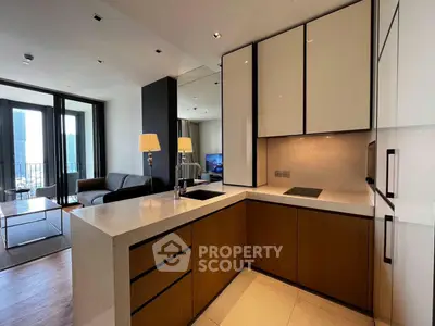 Modern open-layout kitchen with sleek cabinetry and spacious living area, featuring floor-to-ceiling windows and elegant decor.