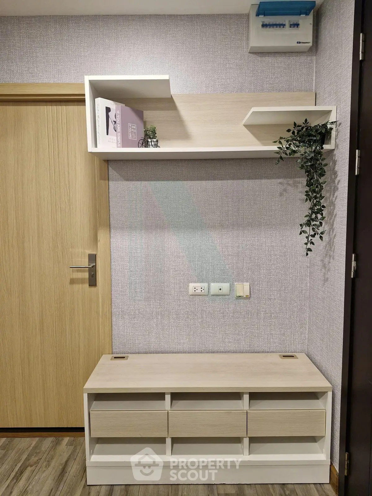 Modern entryway with stylish shelving and storage bench in a contemporary apartment.