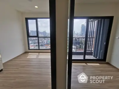 Spacious high-rise corner unit with expansive city views, featuring large windows and a private balcony for an urban oasis feel.