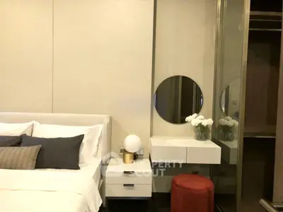 Luxurious bedroom with elegant decor and modern furnishings, featuring a stylish vanity and plush bedding.