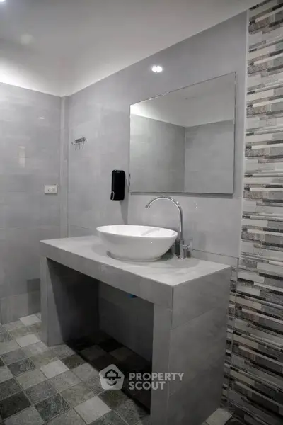 Modern bathroom with stylish sink and tiled walls