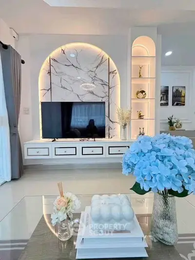 Luxurious living room with elegant marble wall and modern decor