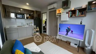 Modern living room with open kitchen, stylish decor, and smart TV setup.