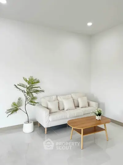 Minimalist living room with white sofa and wooden coffee table