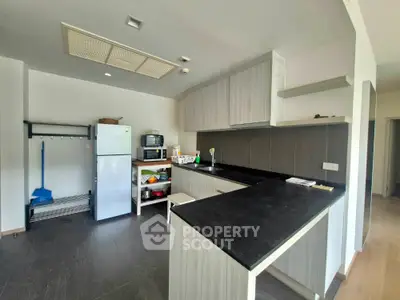 Modern kitchen with sleek black countertops and ample storage space