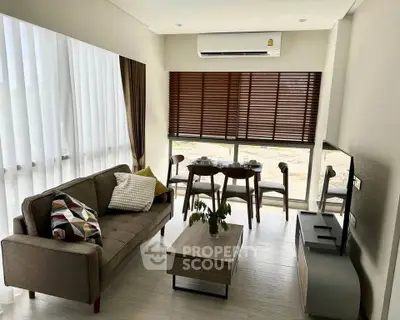 Modern living room with stylish furniture and large windows for natural light.