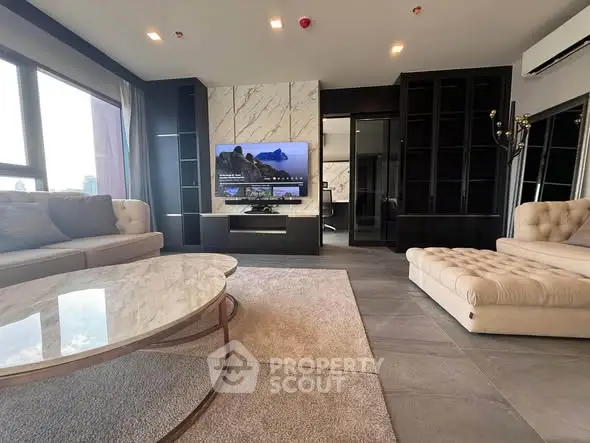 Luxurious modern living room with elegant marble accents and spacious seating area.