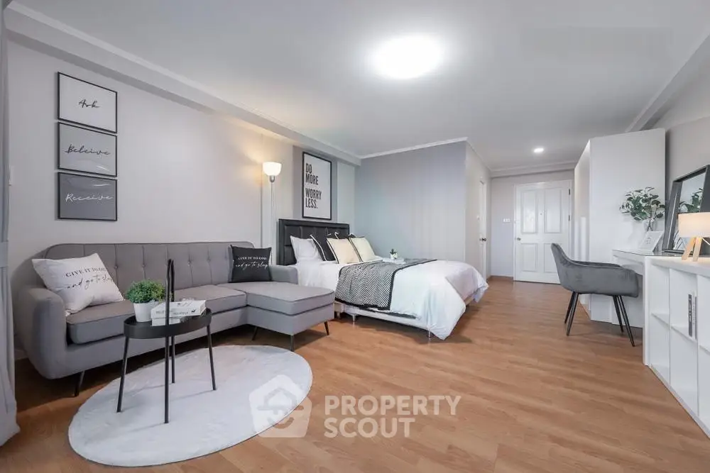 Spacious modern studio apartment with stylish decor and cozy living area.