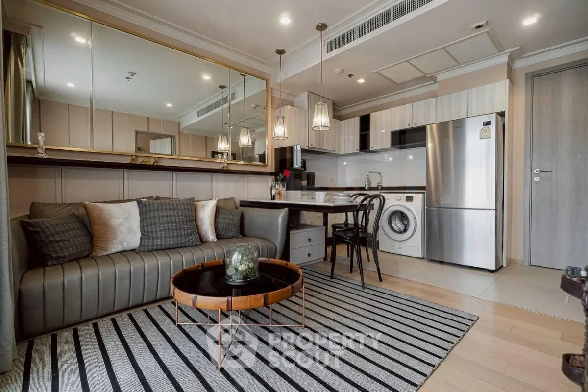Modern living room with open kitchen, stylish decor, and sleek appliances in a cozy apartment.