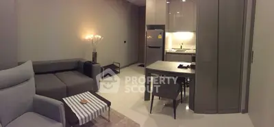 Modern living room with sleek kitchen and cozy seating area