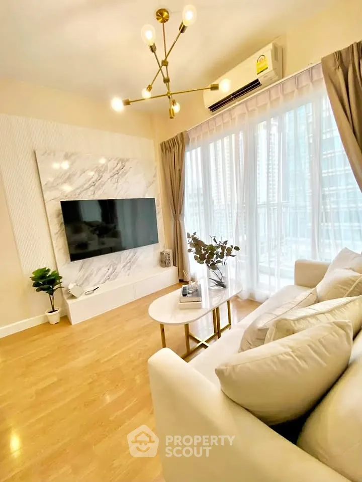 Luxurious living room with modern decor and large windows offering city views.